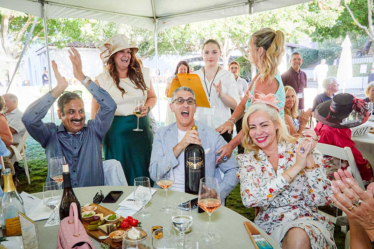 wine auction group celebrating